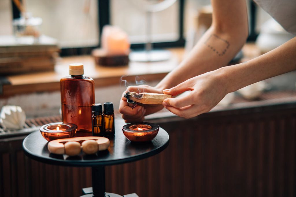 A calming aromatherapy setup with essential oils and incense for relaxation and self-care rituals.