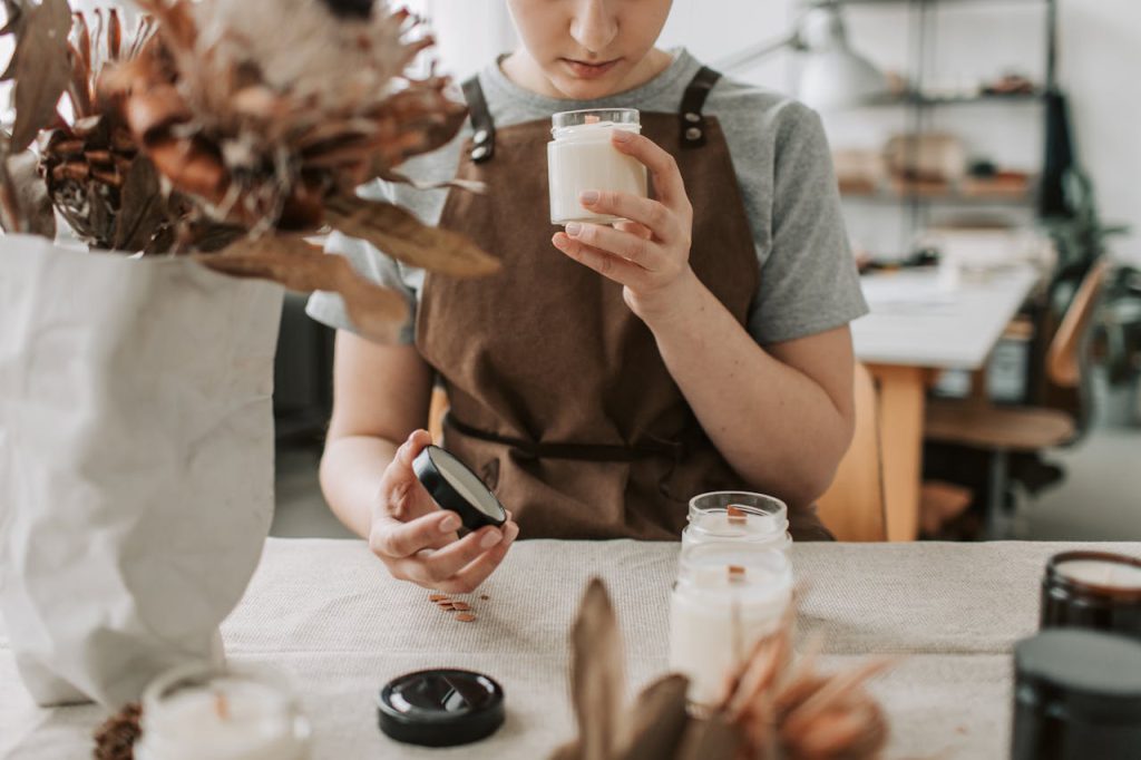 pexels-photo-6755797 A woman crafting candles in a rustic workshop, focusing on scents and quality.