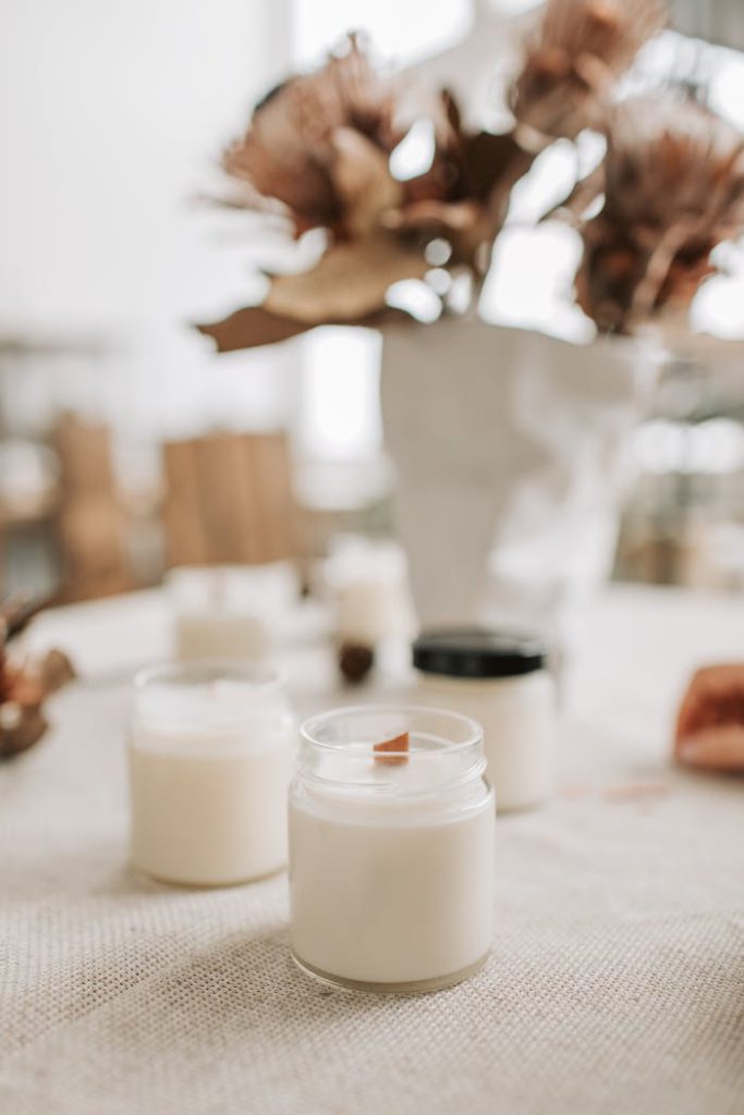 pexels-photo-6755807 Close-up of handmade candles with wooden wicks in glass jars, showcasing artisan quality.