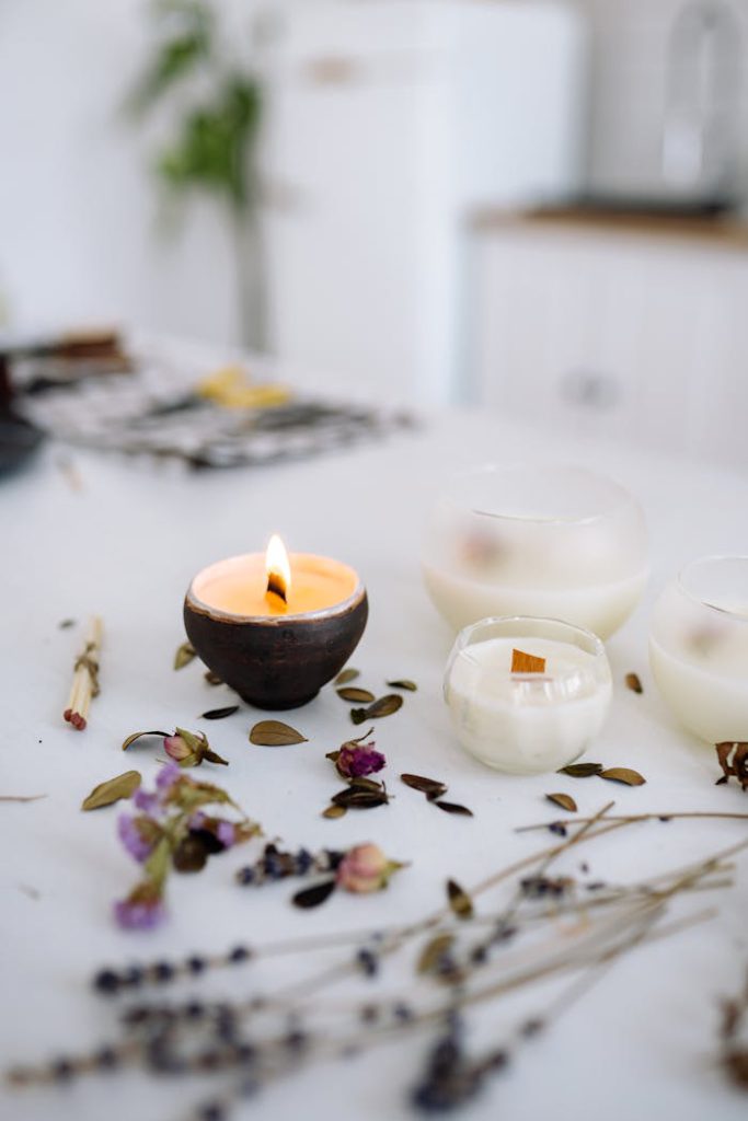 pexels-photo-7233926 Elegant candles on a table with scattered dried flowers creating a warm, serene atmosphere.
